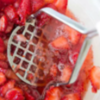 Mashing strawberries for jam
